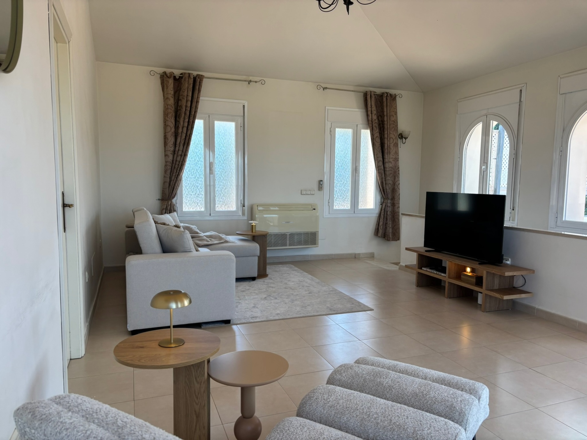 The living room · Vaulted ceilings and soft afternoon light