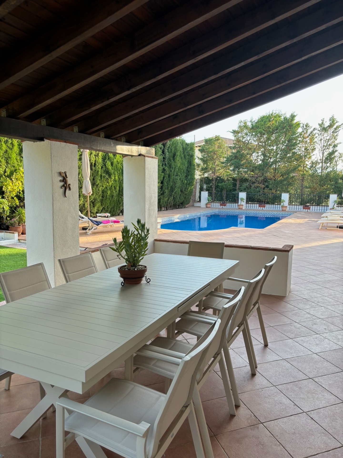 Shaded terrace · The long table by the pool